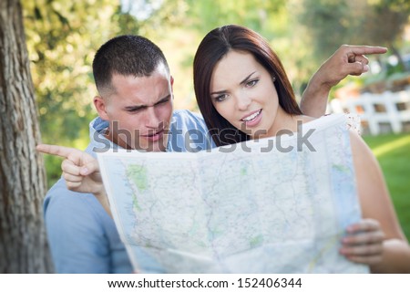 Foto stock: Young Lost And Confused Military Couple Looking At Map In Front