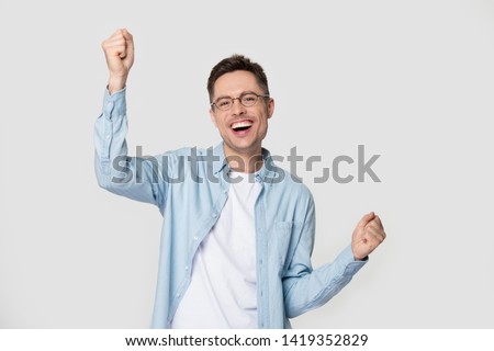 Stock photo: Excited Happy Business Man Posing Isolated Over Grey Wall Background Drinking Coffee