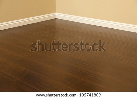 [[stock_photo]]: Newly Installed Brown Laminate Flooring And Baseboards In Home