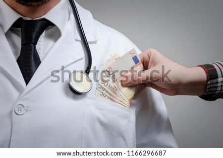 Foto stock: Doctor Received Corruption Money Hand Putting Money In Patient