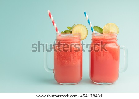 [[stock_photo]]: Healthy Watermelon Smoothie In Mason Jars With Mint And Striped Straws On A Wood Background