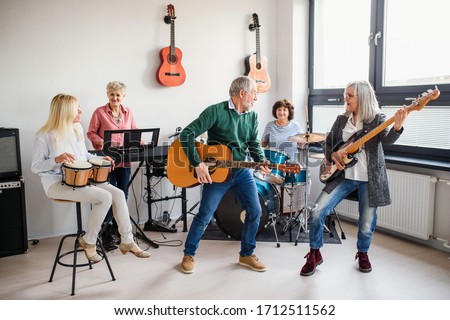 Stockfoto: Front View Of Group Of Active Senior People Performing Exercise At Home