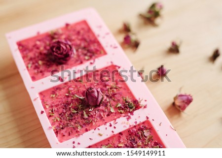 Stockfoto: Handmade Soap Sprinkled By Grated Floral Petals With Small Pink Rosebuds On Top