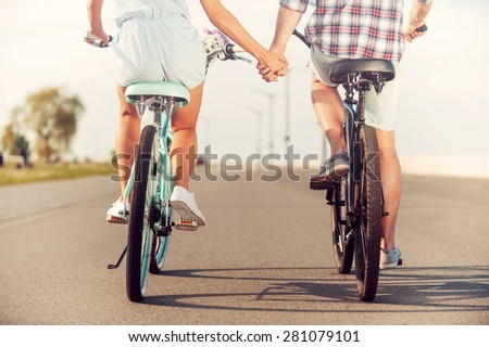[[stock_photo]]: Rear View Of Young Caucasian Couple Holding Bicycle While Walking On Pavement Near Promenade At Beac