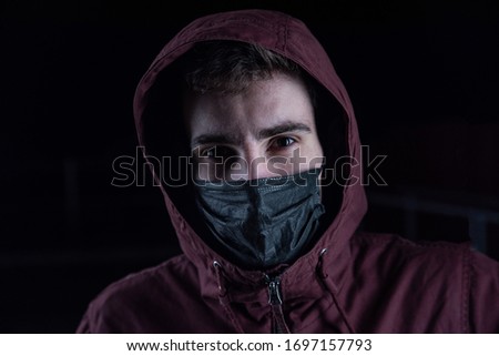 Stock photo: Criminal In Black Leather Jacket And Balaclava On Head Crossing Arms By Chest