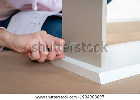 Zdjęcia stock: Caucasian Woman Using Screwdriver For Assembling Furniture Banner Long Format