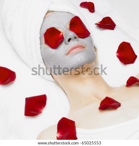 Stock photo: Portrait Of Lying Down Woman With Rose Foils