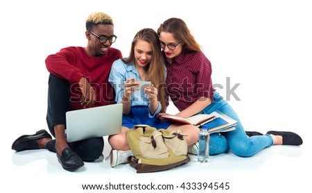 Stock photo: Three Students Sitting With Books Laptop And Bags Isolated On W