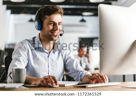 Сток-фото: Photo Of Businesslike Man 20s Wearing Office Clothes And Headset