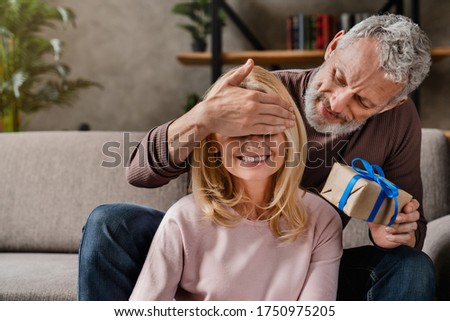 Foto stock: Christmas Gift Box Presented In The Middle Of Christmas Decorations On Wooden Planks