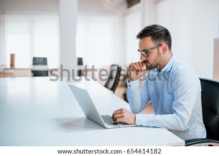 [[stock_photo]]: Attractive Business Man Working On Laptop At Modern Office For H