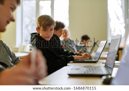 Сток-фото: Clever Boy And His Classmate Looking At Data On Computer Monitor