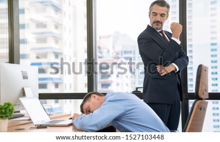 Foto d'archivio: Tired Businessman Sleeping While Working With Laptop And Writing