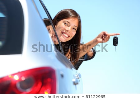 Stockfoto: The Happy Woman Showing The Key Of Her New Car