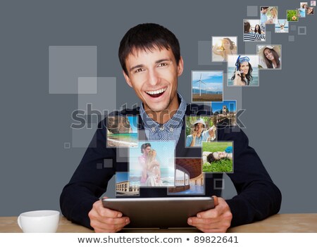Zdjęcia stock: Portrait Of Young Happy Man Sharing His Photo And Video Files In