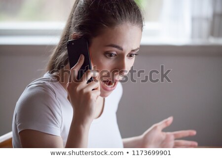 Stockfoto: Woman Receiving Surprising News Over The Telephone