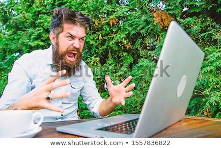 [[stock_photo]]: Angry Man Coming Out From Laptop