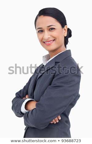 Stok fotoğraf: Close Up Of Smiling Saleswoman With Arms Crossed Against A White Background