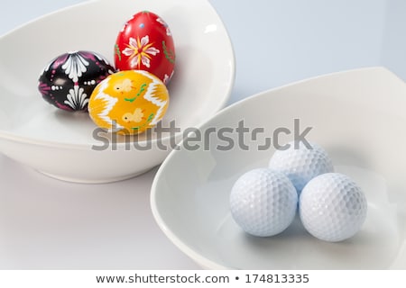 Сток-фото: White Ceramics Bowls Golf Balls And Eggs