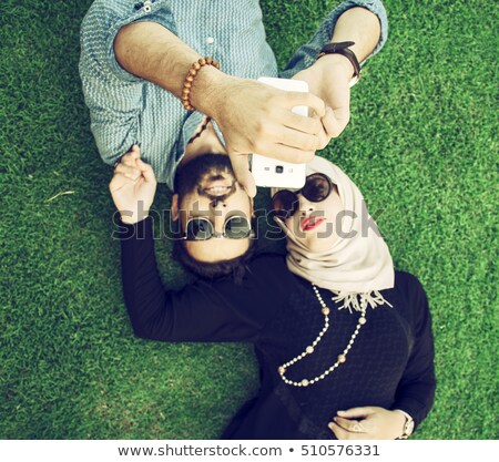 Stock photo: Teenage Boy Lying On Grass With Phone