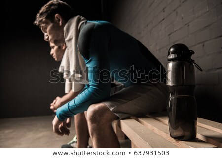 Сток-фото: Tired Man Sitting In The Locker Room