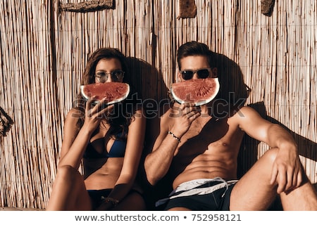 Сток-фото: Young Beautiful Couple In Love Relaxing On A Picnic Outdoor