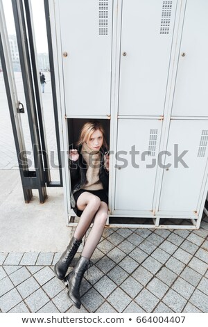 Stock fotó: Serious Young Blonde Lady Sitting In Safe
