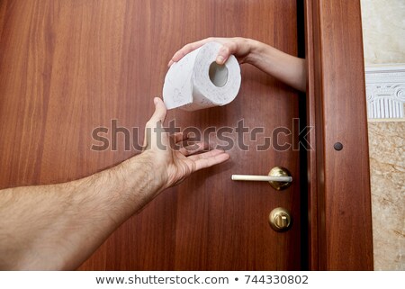 Stockfoto: Hand Passing Toilet Paper
