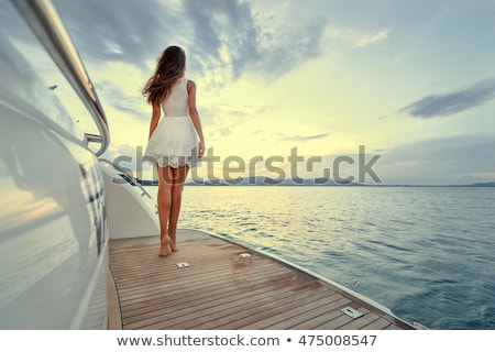 Сток-фото: Young Woman Standing On Yacht At Sea