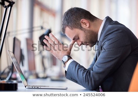 [[stock_photo]]: Young Business Man With Problems And Stress In The Office