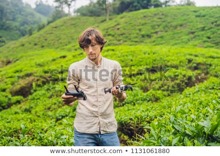 Foto stock: Men Tourist Tries To Launch The Drone At A Tea Plantation Natural Selected Fresh Tea Leaves In Tea