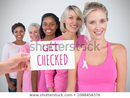 Foto d'archivio: Get Checked Text And Hand Holding Card With Pink Breast Cancer Awareness Women