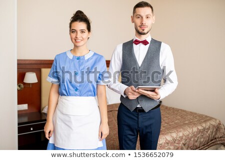 Foto stock: Happy Young Chamber Maid In Uniform And Elegant Porter With Touchpad