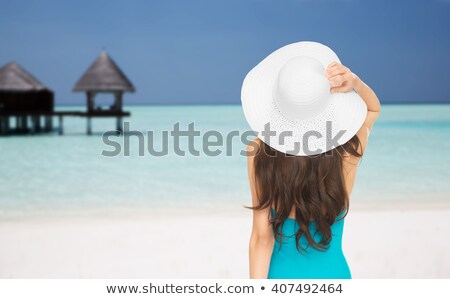 Foto stock: Unrecognizable Woman In A Swimsuit On The Ocean Coast Rear View