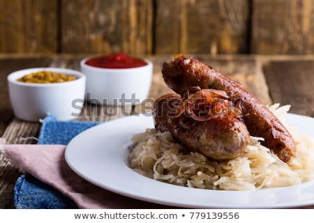 Foto stock: Roasted Sausages With Sauerkraut - Polish Dish