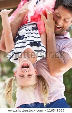 Foto d'archivio: Playful Father And Daughter Having Fun In Garden