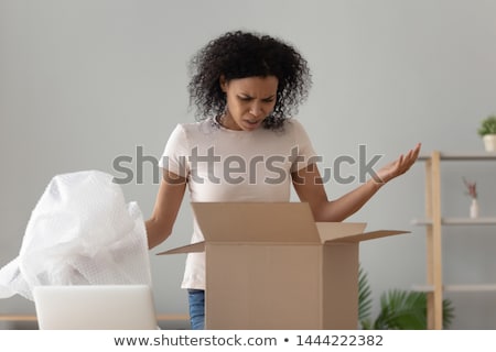 ストックフォト: Disappointed Woman Unpacking Online Purchase At Home