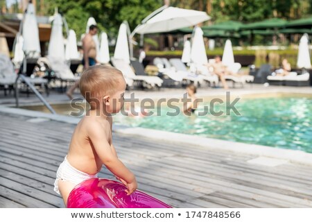 Foto d'archivio: Toddler Baby Kid In Summer Sun Tanning On Wood
