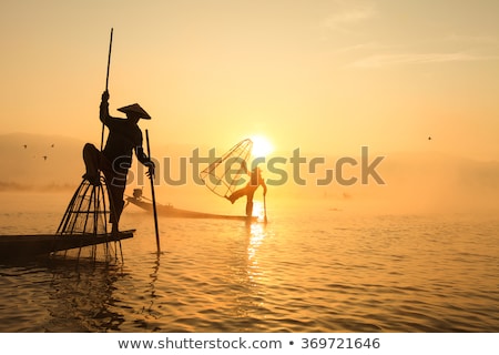 Сток-фото: Burmese Fisherman Catching Fish In Traditional Way Inle Lake Myanmar