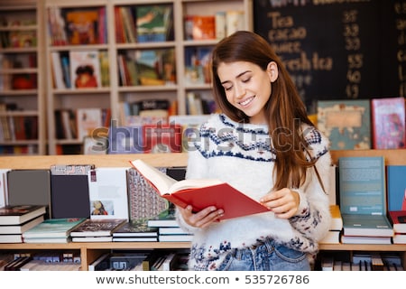 Сток-фото: Portrait Of Female Customer Reading Book In Bookstore