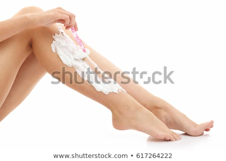 Stock fotó: Woman Shaves Her Leg Isolated On White Background