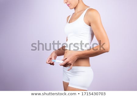 Zdjęcia stock: Young Woman In Bathroom Is Happy About The Result Of Pregnancy T