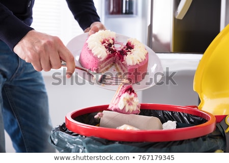 [[stock_photo]]: Man Throwing Cake In Trash Bin