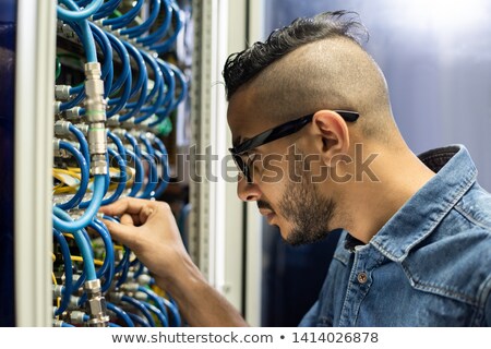 Stock foto: Busy Arabian Engineer Connecting Broadband Cables