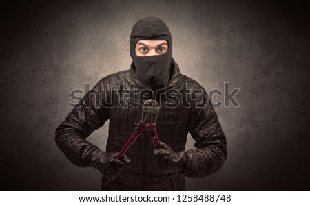 [[stock_photo]]: Gangster In Black Jacket And Balaclava On Head Standing On Background Of Car