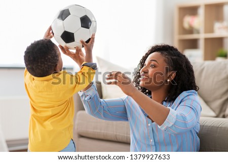 Stock photo: Mother And Baby Playing With Soccer Ball At Home