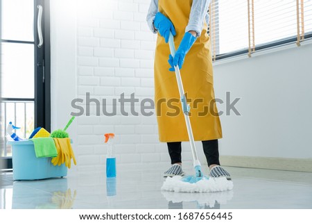 Stok fotoğraf: Woman Housekeeper With Mop And Bucket With Cleaning Agents For C