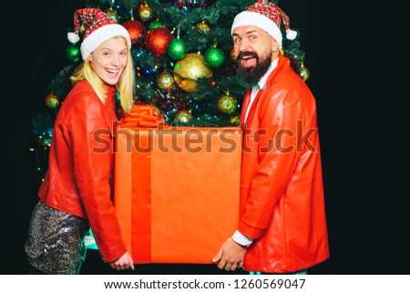 Stockfoto: Christmas Woman Near A Christmas Tree Holding Big Gift Box While