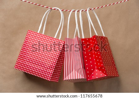 Zdjęcia stock: Red Gift Package Paper Bags Hanging On A Ribbon Old Brown Paper