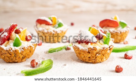 Stockfoto: Christmas Cupcakes With Strawberries And Powdered Sugar On Black Background Top View